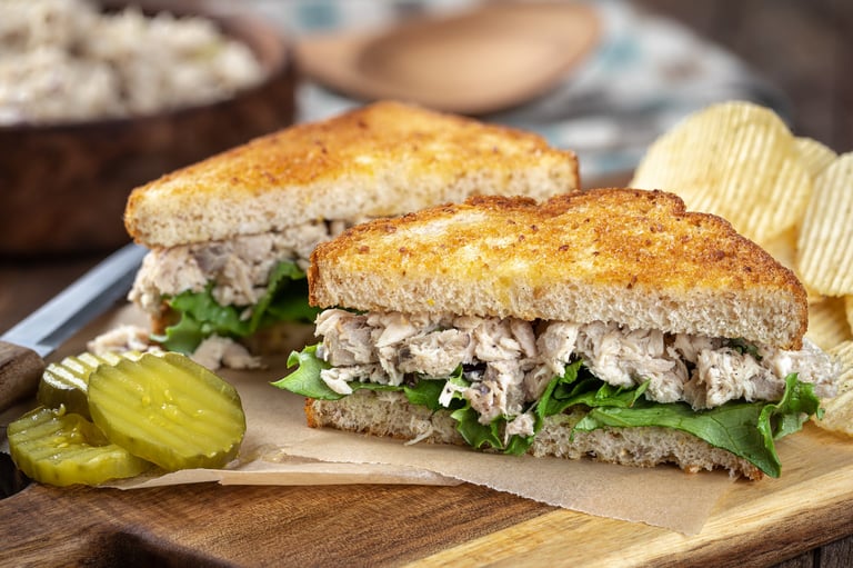 Tuna salad sandwich with lettuce on toasted whole grain bread