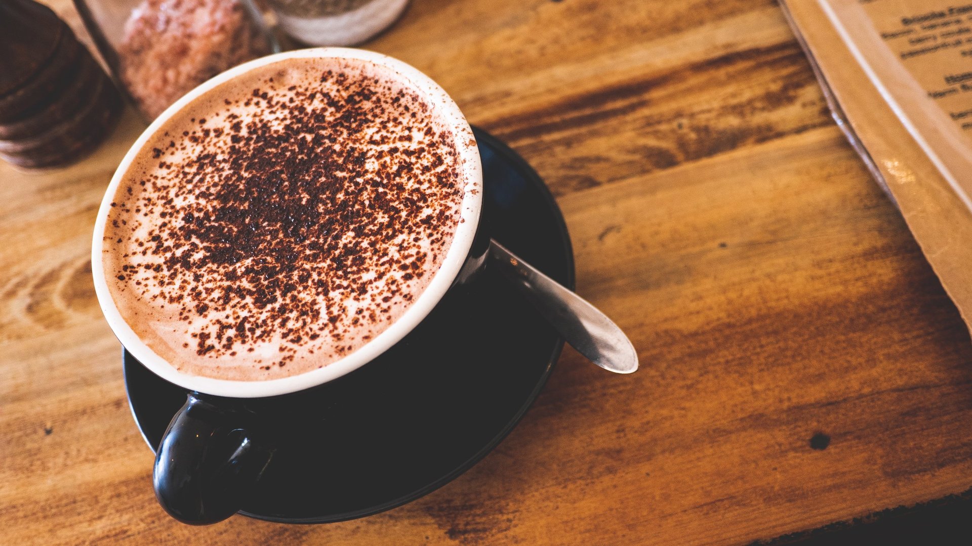 A cup of coffee cappuccino latte with chocolate cinnamon powder froth appetizing