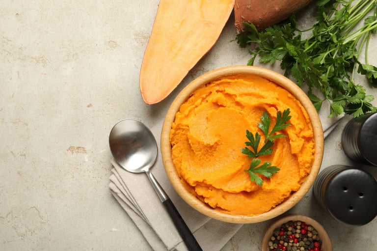 Tasty mashed sweet potato and parsley in bowl
