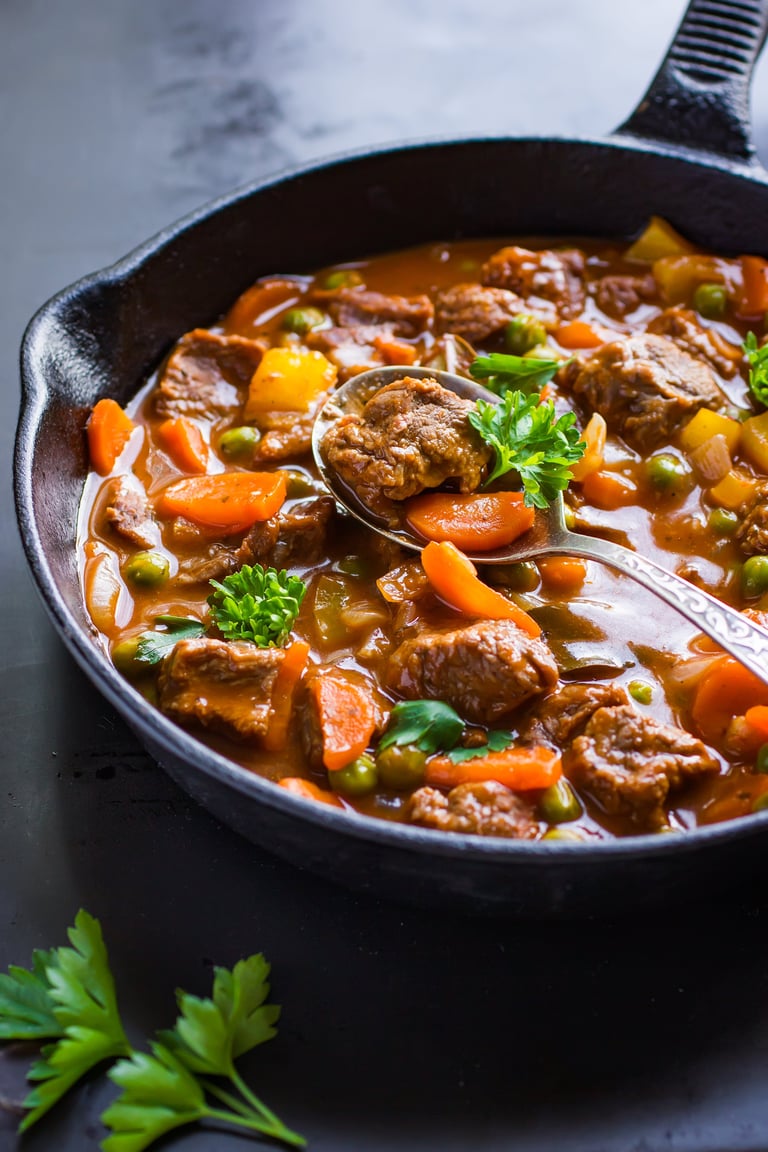 Beef stew with vegetables on dark background