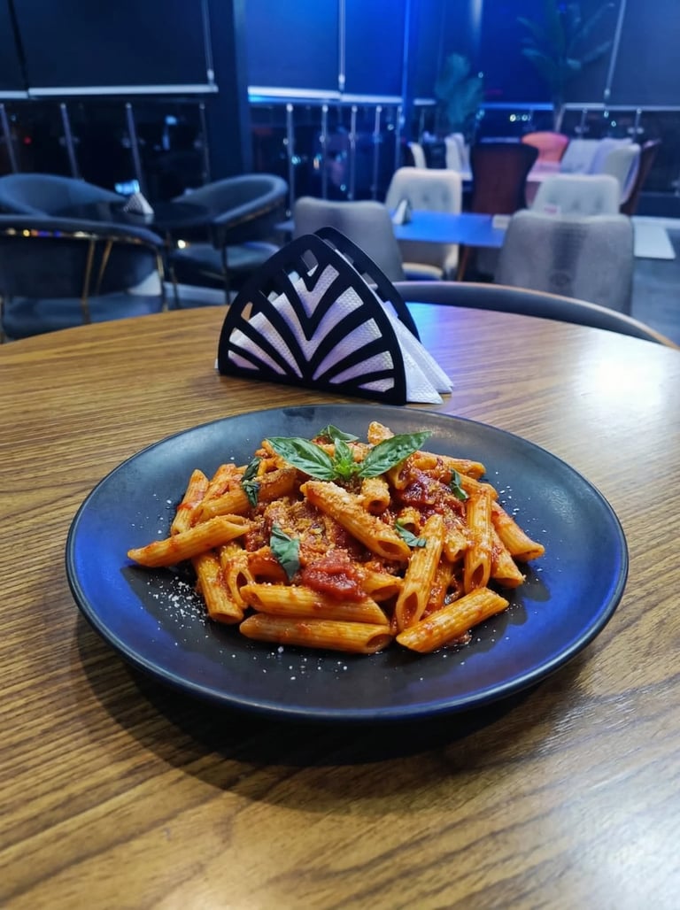Plate of crispy golden fries with red sauce and fresh herbs on a wooden table in a modern restaurant with blue windows and seating area