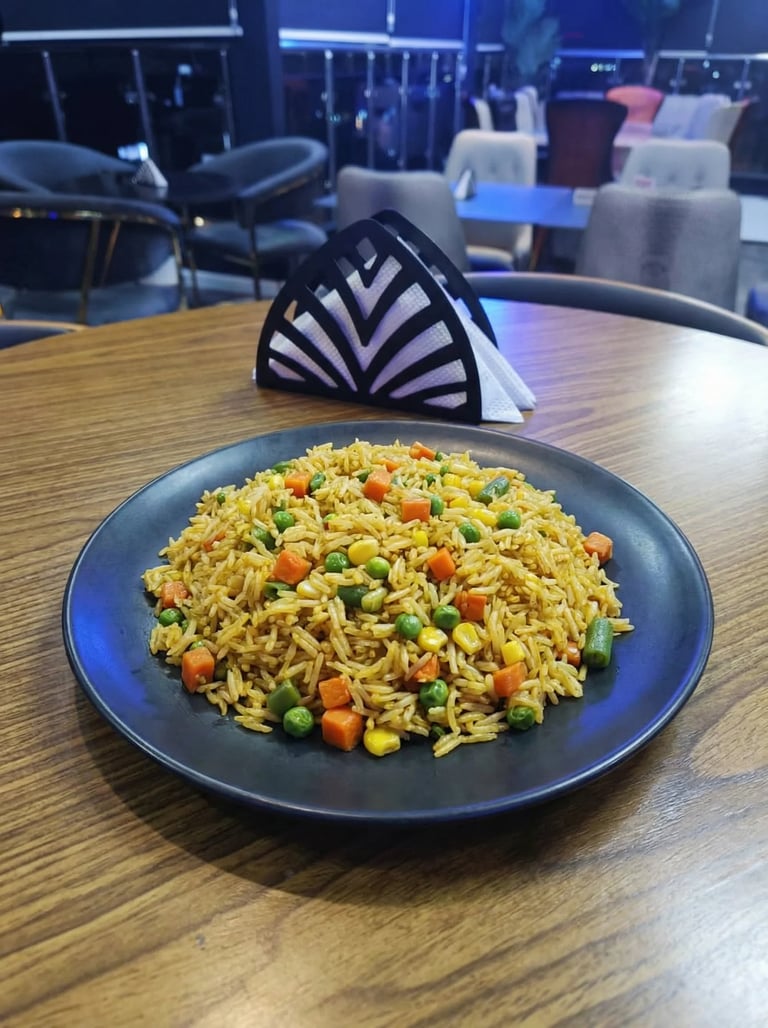 Bowl of fried noodles with mixed vegetables on a wooden table in a modern cafe setting